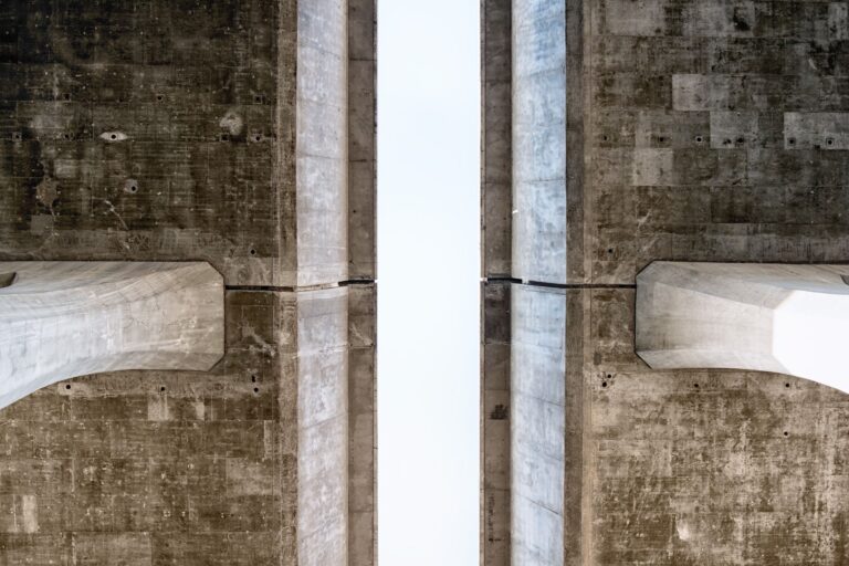 Close-up view of a symmetrical concrete structure showcasing texture and geometry.
