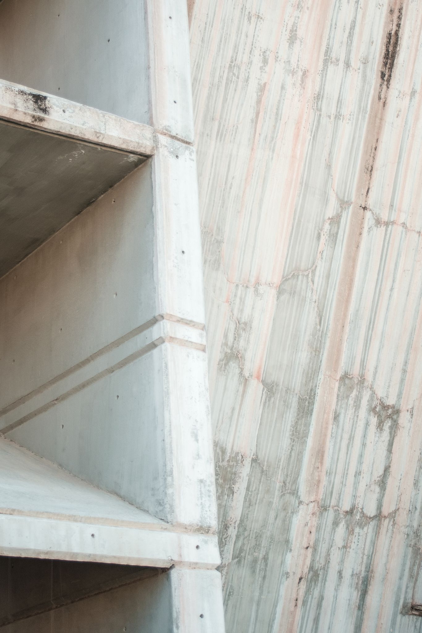 Minimalist concrete structure highlighting lines and textures in an urban setting.